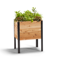 An 18-inch by 24-inch raised garden bed made of rot-resistant western red cedar, with a free protective liner and built-in drainage. It is shown filled with plants and set on a black background.