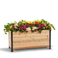 An 18" x 48" wooden planter box filled with colorful flowers, showcasing the product's scale and use.