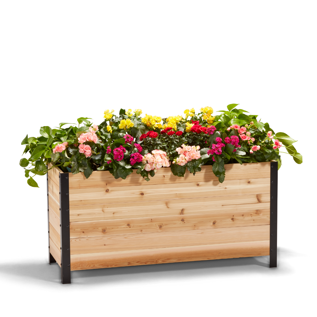 An 18" x 48" wooden planter box filled with colorful flowers, showcasing the product's scale and use.