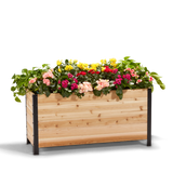 An 18" x 48" wooden planter box filled with colorful flowers, showcasing the product's scale and use.