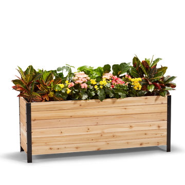 A wooden planter box measuring 18 inches wide, 60 inches long, and 24 inches tall, filled with colorful flowers.